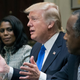 President Donald Trump with Omarosa Manigault (left) and Ben Carson (right) in the Roosevelt Room of the White House on Feb. 1, 2017 (Michael Reynolds-Pool/Getty Images)
